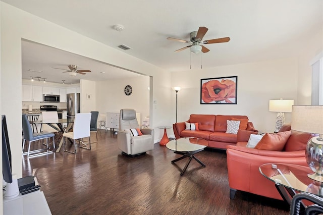 living room with ceiling fan and dark hardwood / wood-style floors