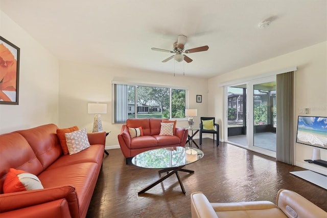 living room with dark hardwood / wood-style floors, ceiling fan, and a healthy amount of sunlight