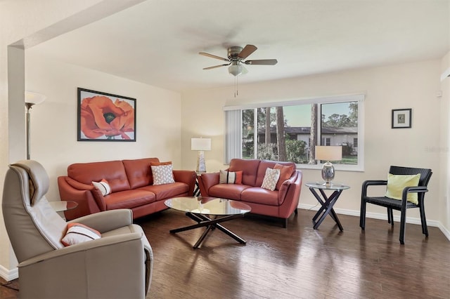 living room with dark hardwood / wood-style flooring and ceiling fan