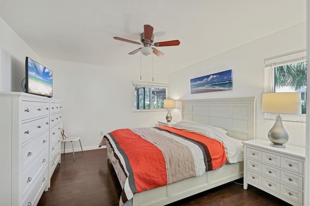 bedroom featuring multiple windows, dark hardwood / wood-style flooring, and ceiling fan