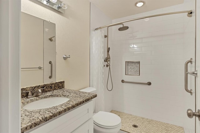 bathroom featuring vanity, curtained shower, and toilet