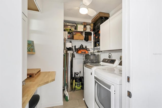 washroom featuring ceiling fan, washer and clothes dryer, light tile patterned floors, and cabinets