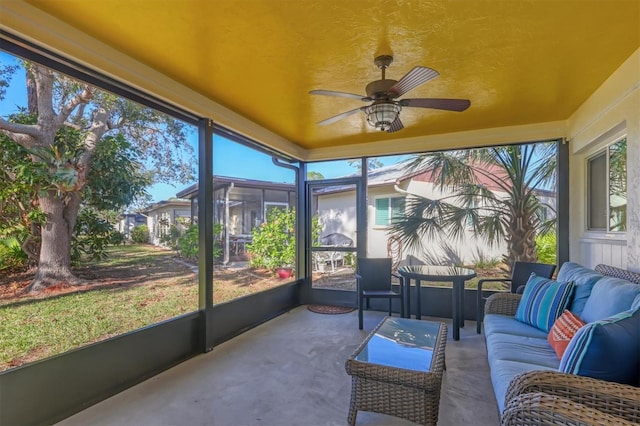 sunroom / solarium featuring ceiling fan