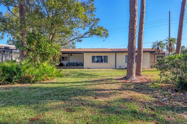 rear view of house with a lawn