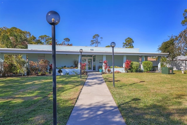 single story home with french doors and a front lawn