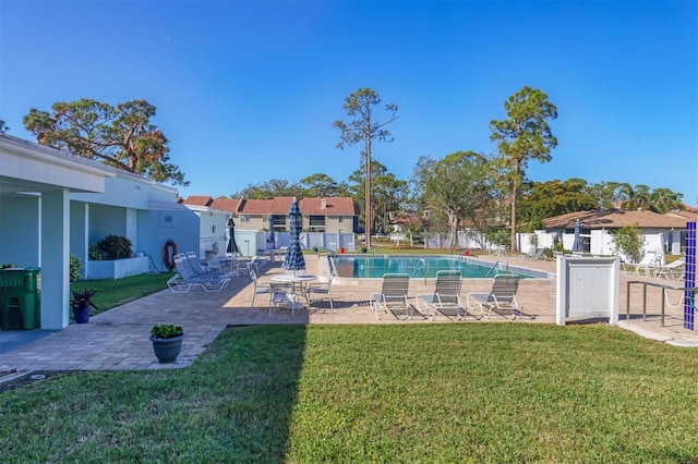 view of swimming pool with a yard and a patio area