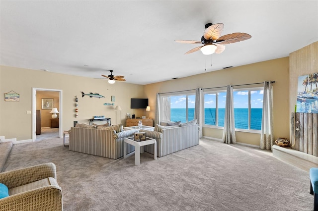 carpeted living room with ceiling fan