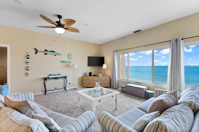 living room with ceiling fan and light colored carpet