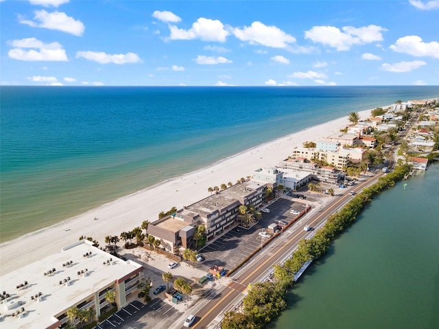 birds eye view of property with a beach view and a water view