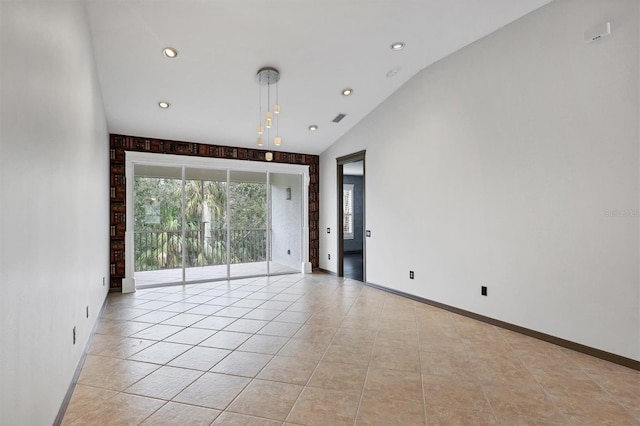 tiled spare room featuring lofted ceiling