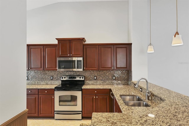 kitchen featuring tasteful backsplash, stainless steel appliances, decorative light fixtures, and sink