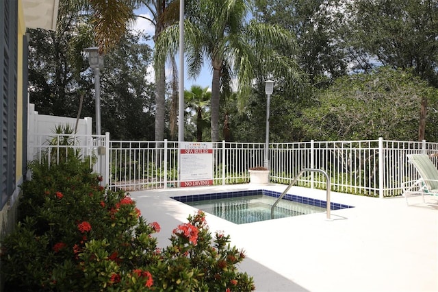 view of pool with a hot tub