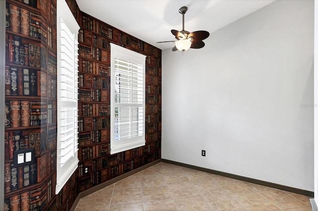 empty room featuring light tile patterned floors and ceiling fan