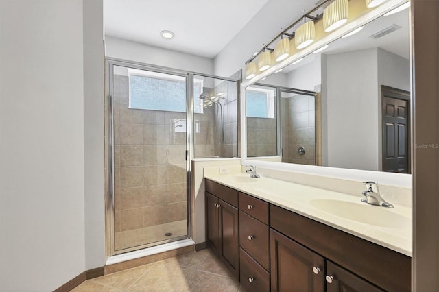 bathroom featuring tile patterned floors, a shower with door, and vanity