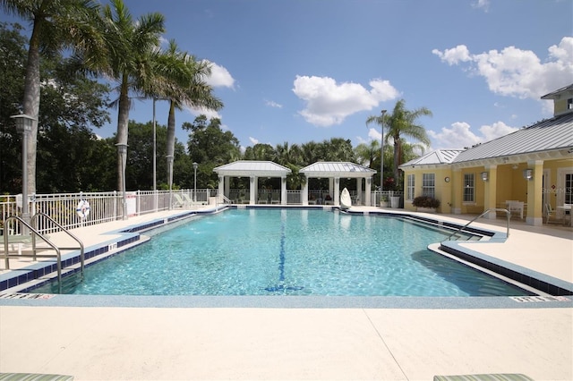 view of swimming pool with a patio and a gazebo