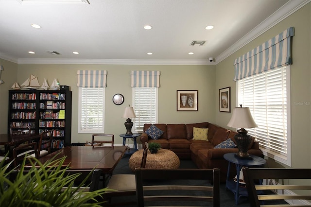 living room featuring ornamental molding and a wealth of natural light