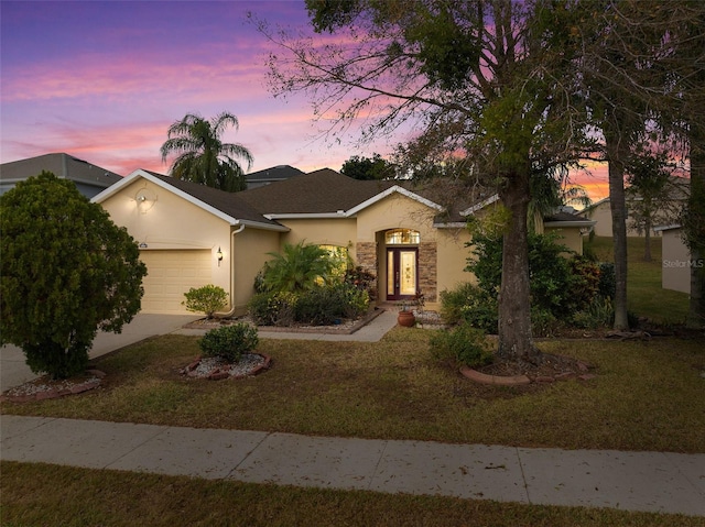 ranch-style house with a lawn and a garage