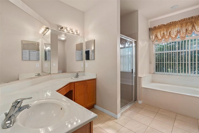 bathroom featuring tile patterned flooring, shower with separate bathtub, and vanity