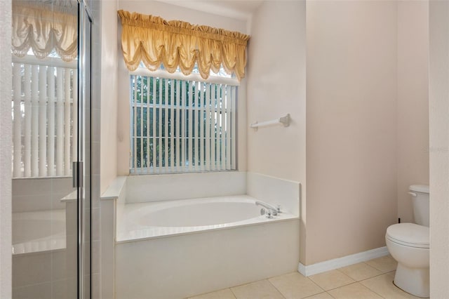 bathroom featuring tile patterned floors, toilet, and shower with separate bathtub