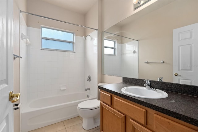 full bathroom featuring tile patterned floors, vanity, toilet, and tiled shower / bath combo