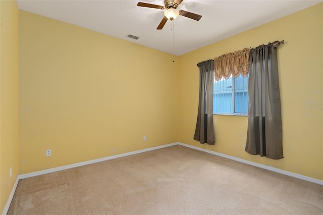 empty room with light colored carpet and ceiling fan