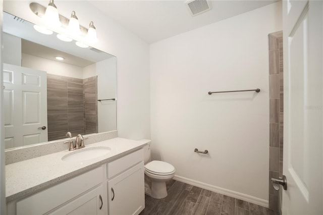 bathroom with vanity, toilet, and wood-type flooring