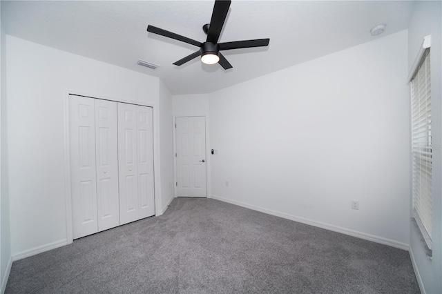 unfurnished bedroom with carpet flooring, ceiling fan, and a closet