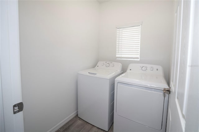 laundry area featuring washer and clothes dryer and hardwood / wood-style floors