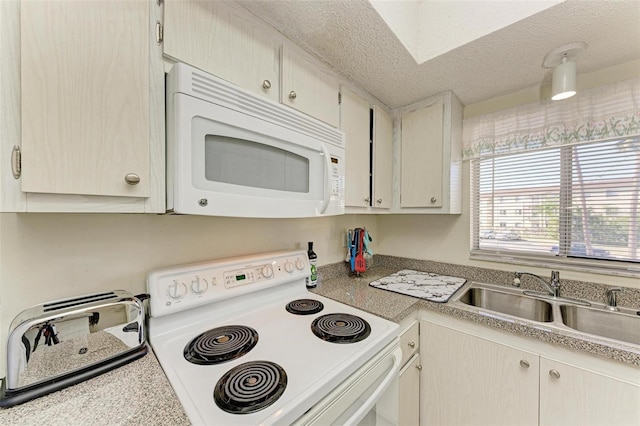 kitchen featuring a textured ceiling, sink, and white appliances