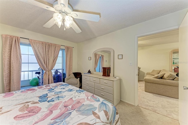 bedroom with light carpet, a textured ceiling, and ceiling fan