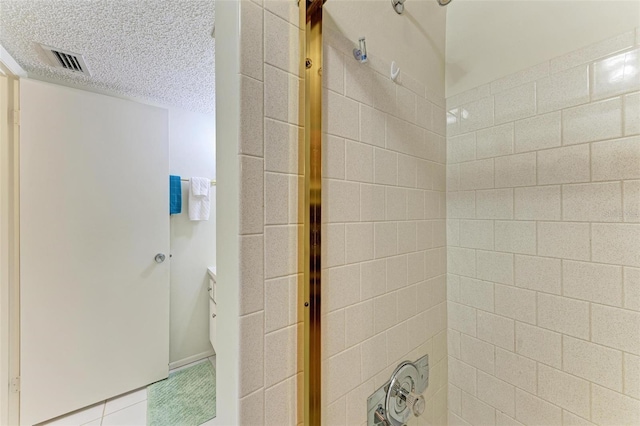 bathroom featuring tile patterned floors and a textured ceiling