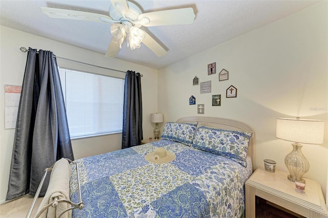 carpeted bedroom featuring a textured ceiling and ceiling fan