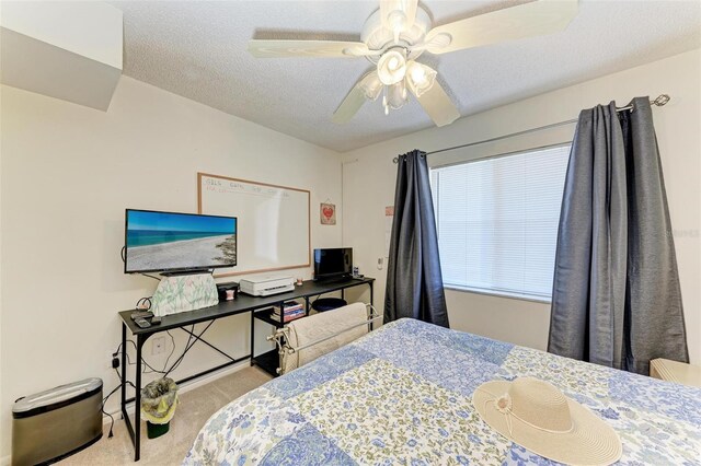 carpeted bedroom with a textured ceiling and ceiling fan