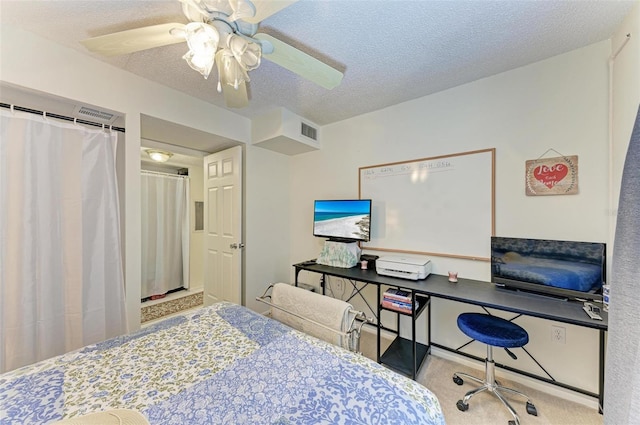 carpeted bedroom with a textured ceiling and ceiling fan