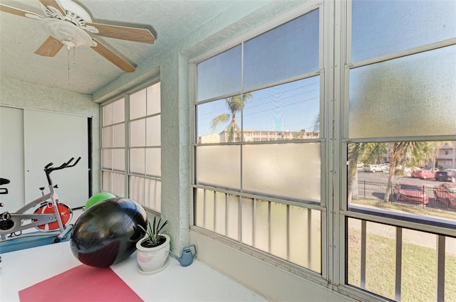 sunroom featuring ceiling fan