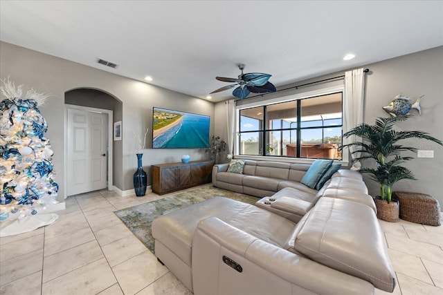 living room featuring ceiling fan and light tile patterned flooring