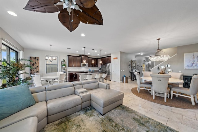 tiled living room with an inviting chandelier