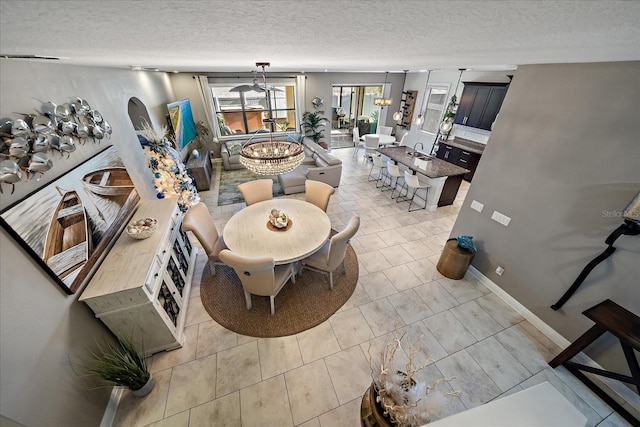 dining room with light tile patterned floors and a textured ceiling