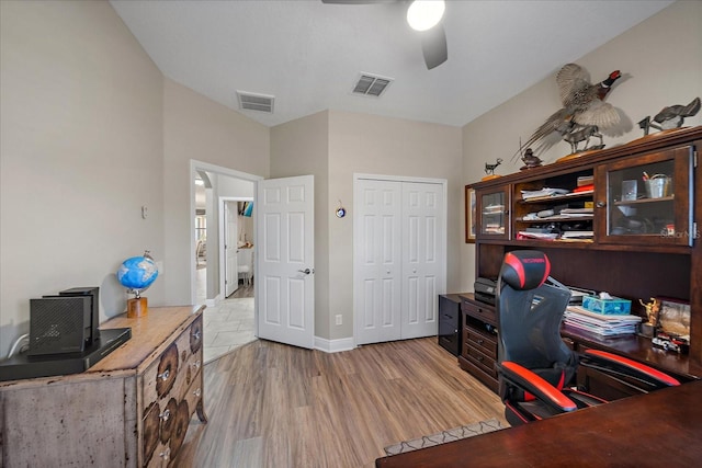 home office with ceiling fan and light wood-type flooring