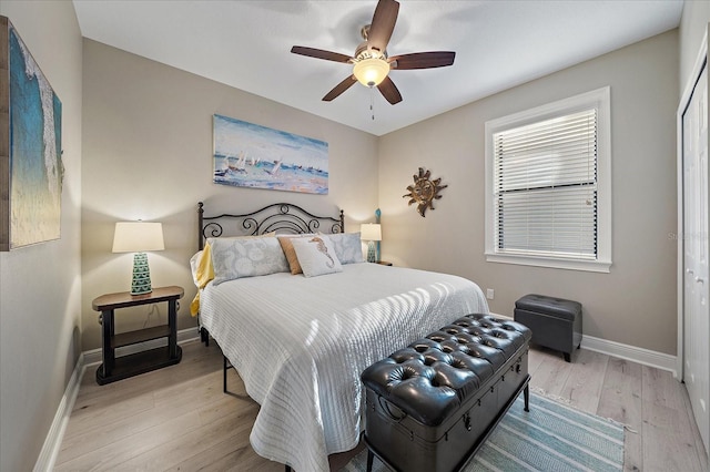 bedroom featuring ceiling fan, a closet, and light wood-type flooring