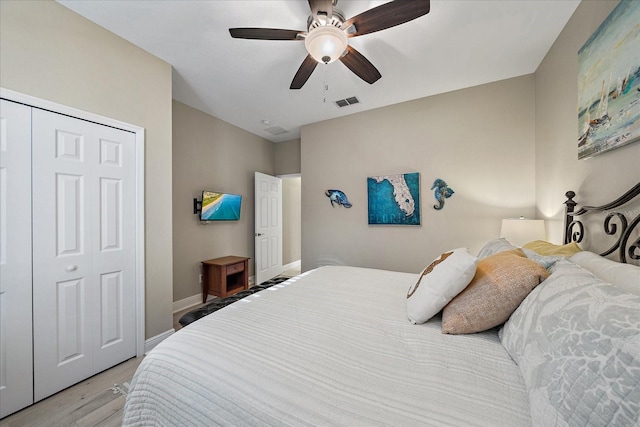 bedroom with ceiling fan, a closet, and light wood-type flooring