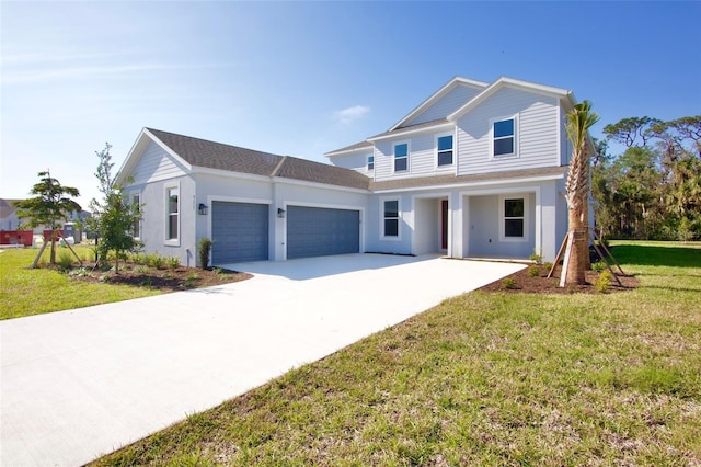 view of front of home with a front yard and a garage