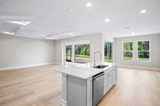 kitchen with dishwasher, sink, coffered ceiling, a center island with sink, and light wood-type flooring