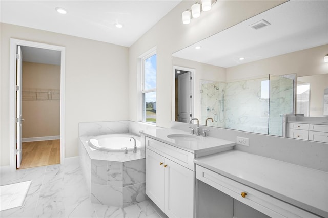 bathroom with vanity and separate shower and tub