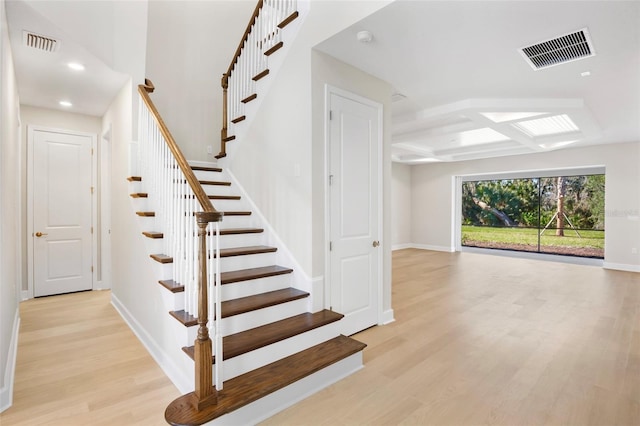 staircase with hardwood / wood-style floors