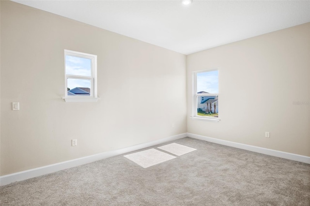 carpeted empty room with plenty of natural light