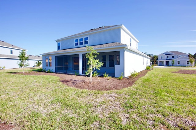 back of property with a lawn and a sunroom