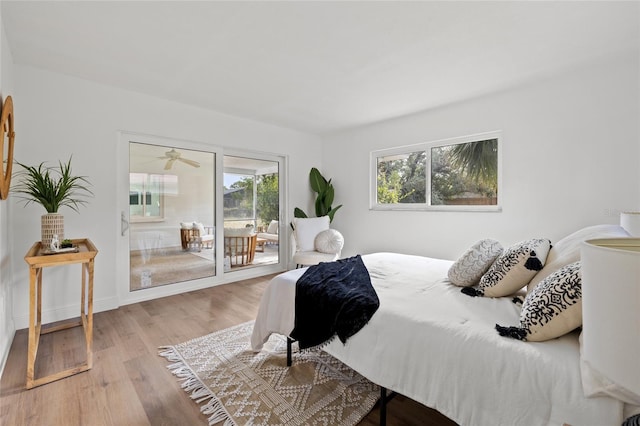 bedroom with access to exterior and light hardwood / wood-style flooring