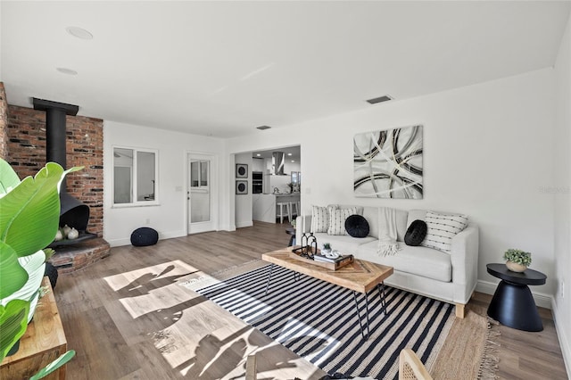 living room featuring hardwood / wood-style flooring and a wood stove