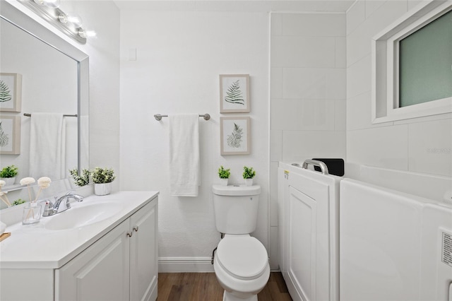 bathroom with toilet, vanity, and hardwood / wood-style flooring